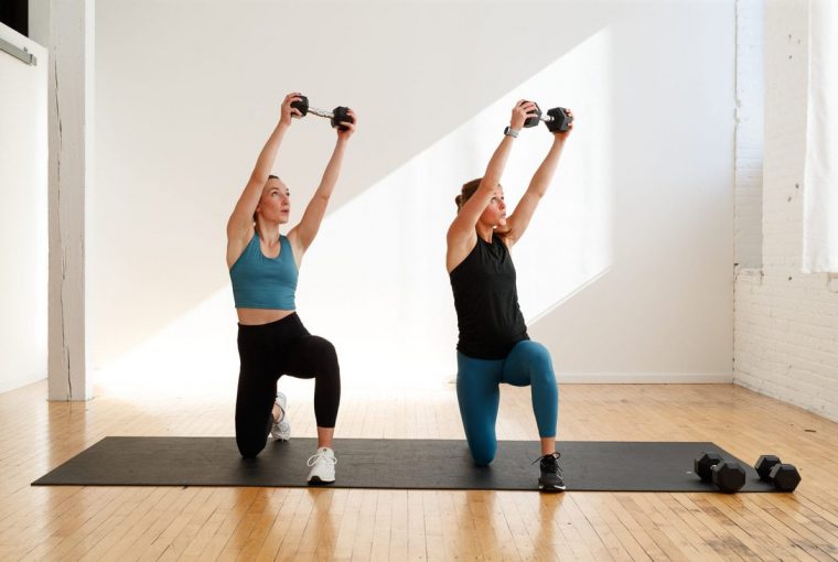 a couple doing a workout in a gym