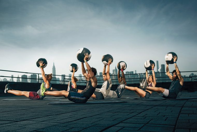 a group of athletes doing core exercises.