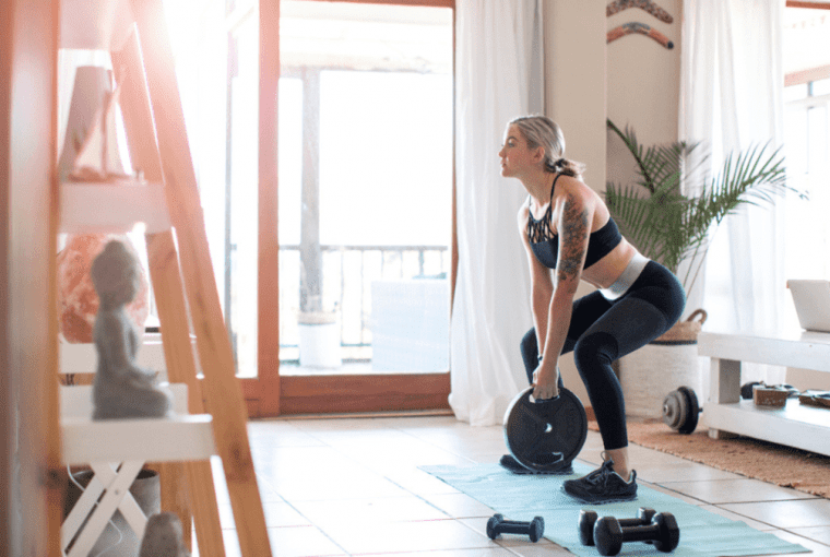 a woman exercising at home in her home gym