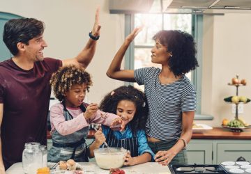 Cropped shot of a young couple baking at home with their two children