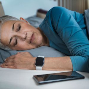 a woman using a sleep tracker