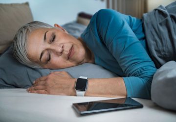 a woman using a sleep tracker
