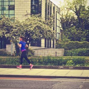 a woman going for a run in a neighbourhood