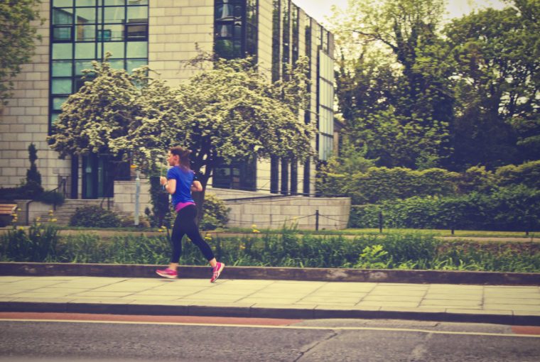 a woman going for a run in a neighbourhood