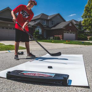 a young hockey player practicing his shooting skills