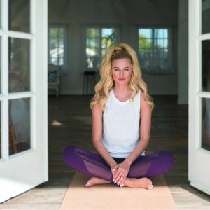 a woman with long hair in a lotus position