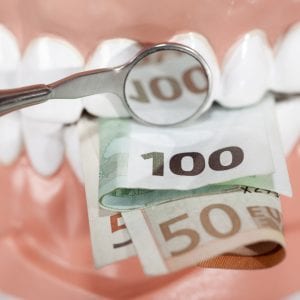 Money in front of teeth