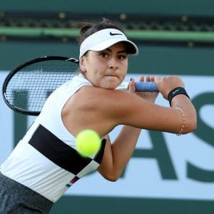 Canadian tennis player hitting a ball