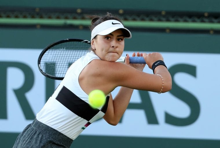 Canadian tennis player hitting a ball
