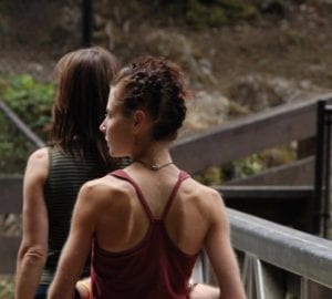 two women walking on a path