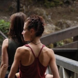 two women walking on a path