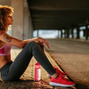 Woman resting in tunnel after run