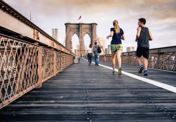 People running on a bridge