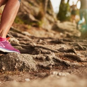 woman running on a muddy trail