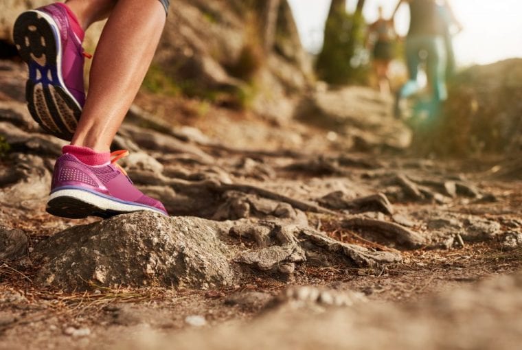 woman running on a muddy trail