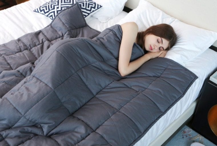 Lady sleeping with weighted blanket