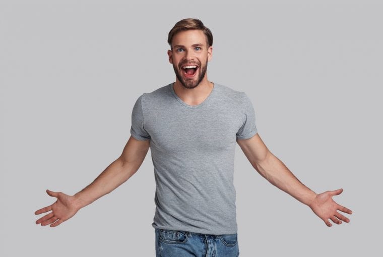 man facing camera with arms out at his side