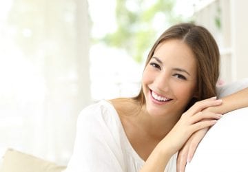 Beauty woman with white perfect smile looking at camera at home