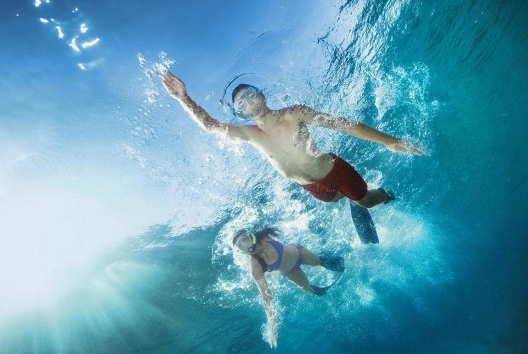a couple of friends snorkeling in the ocean