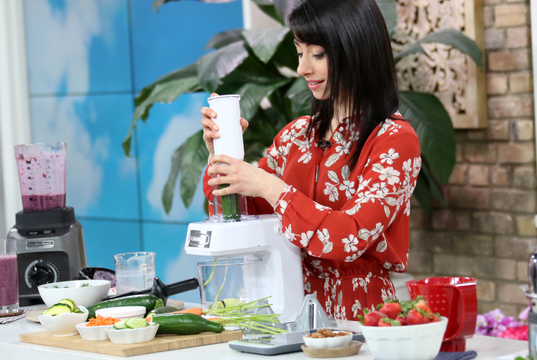 woman putting food through a food processor