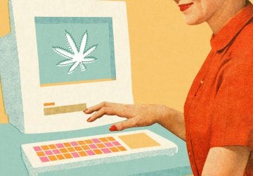 woman sitting in front of a computer ordering CBD