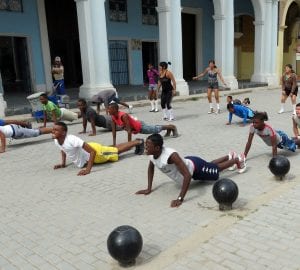 students performing physical exercise outdoors