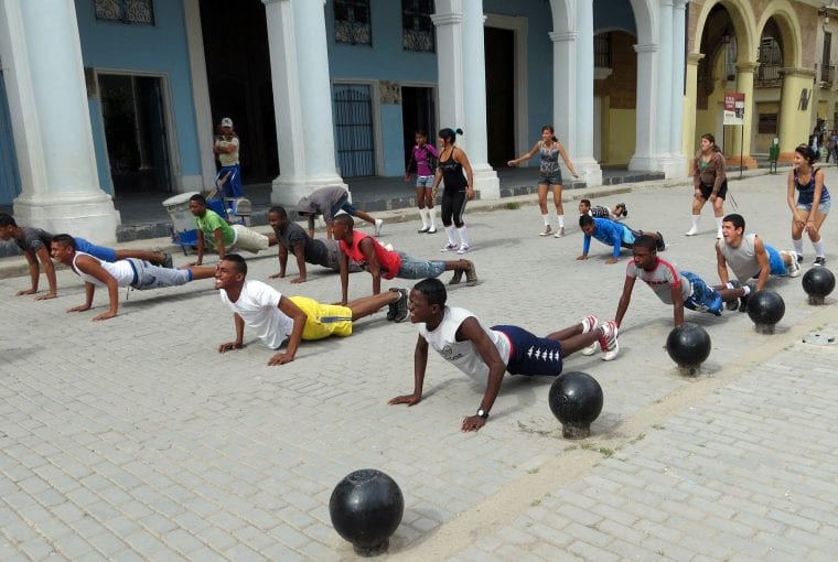 students performing physical exercise outdoors