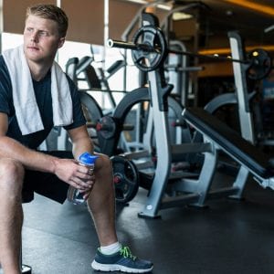 Young man resting after training in the gym