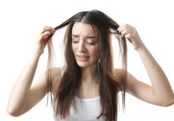 woman holding hair that is falling out
