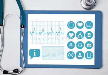 stethoscope beside a tablet showing health information