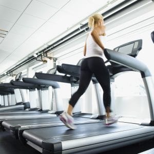 Woman exercising on treadmill in gym