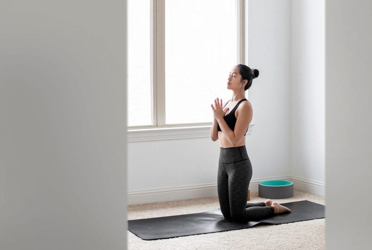 woman doing yoga in her home