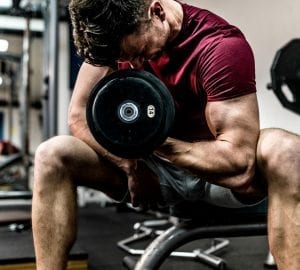 man doing arm curls with dumbell