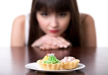 woman looking at a plate of sweets