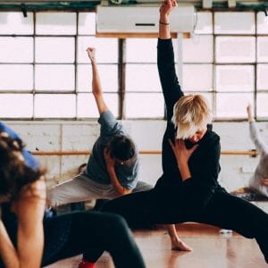 a group of people dancing in a gym