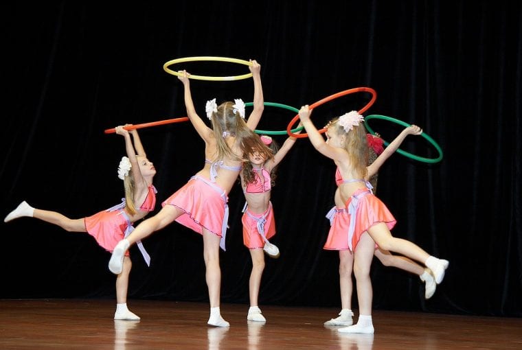 children dancing with hula hoops