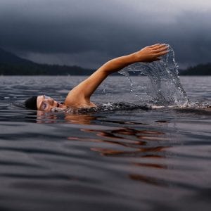 person swimming in a lake.