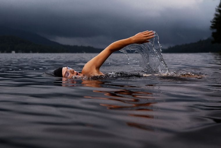 person swimming in a lake.