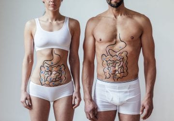healthy man and woman with their digestive systems drawn on their bodies