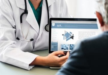doctor reviewing a website with their patient