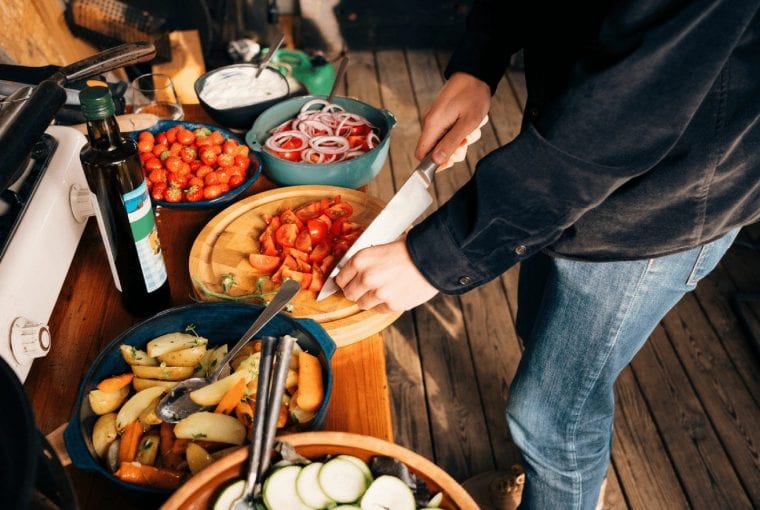 person chopping up some vegetables for meal prep