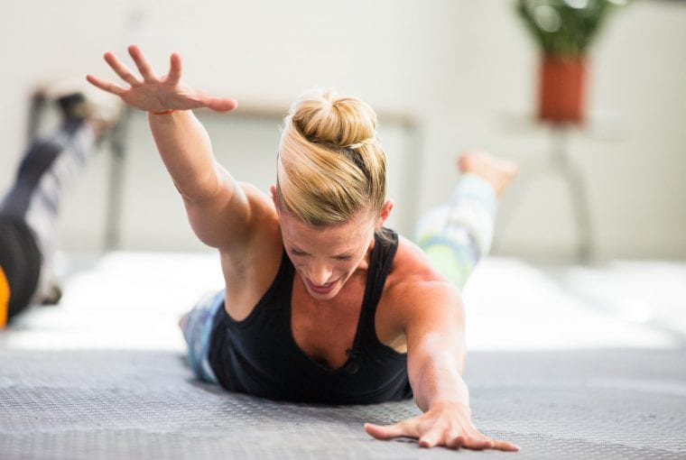 woman lying on the floor exercising her back