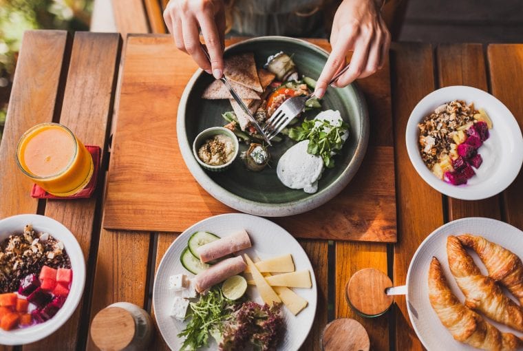person eating an assortment of healthy foods.