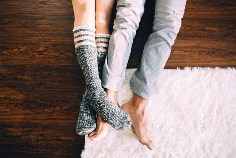 legs of a couple who are lying on the floor