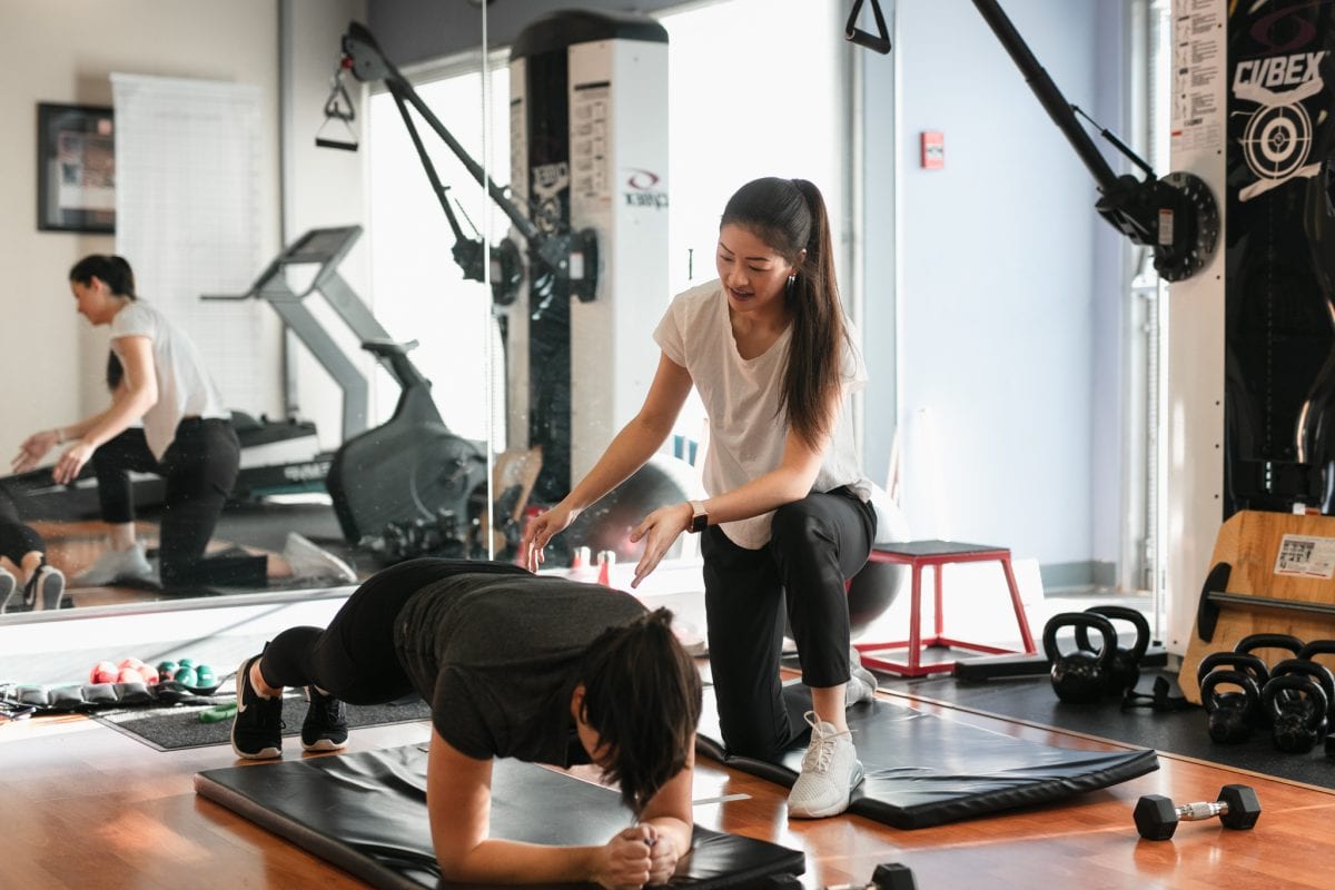 physical therapist working with their patient in the gym