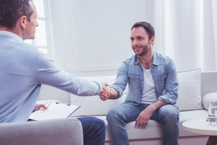 person shaking hands with their counsellor
