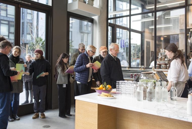 a group of people in line at a restaurant ordering food