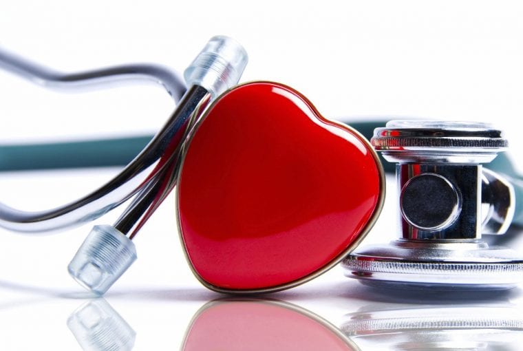 a heart sitting beside a stethoscope