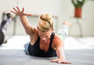 woman lying on the ground doing shoulder exercises