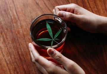 person enjoying a cup of cannabis infused tea